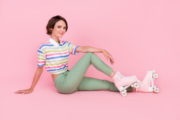 Obraz na płótnie Canvas Full length photo of young beautiful girl happy positive smile sit floor skater rest isolated over pastel color background