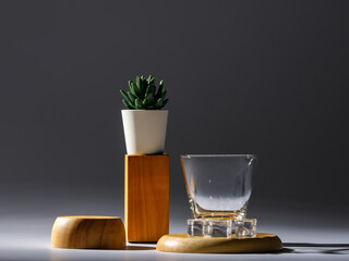 Luxury plant pot and empty drink glass decorated on gorgeous wooden tray on deluxe table for nature preparation of romantic night dining.