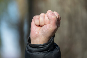 The man's fist is pulled up as a symbol of strength and confidence