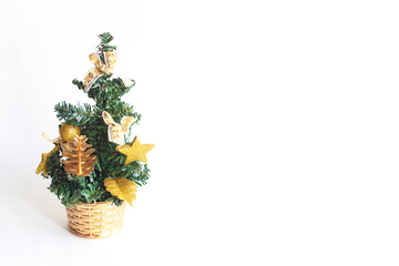 A small Christmas tree with toys in a basket isolated on a white background, copy space