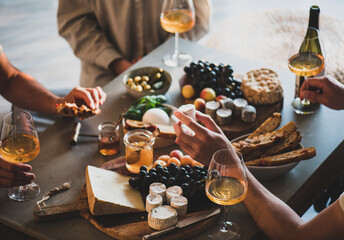 People drinking orange wine eating tasty snacks