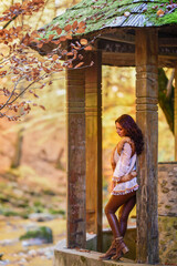 Autumn portrait with a beautiful woman in different positions near a mountain river.