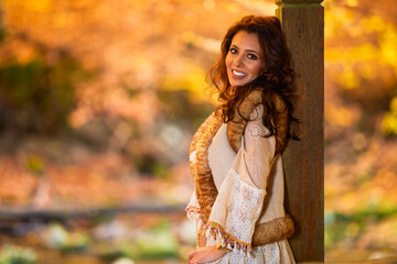 Autumn portrait with a beautiful woman in different positions near a mountain river.