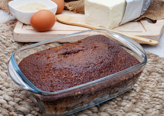 Traditional South African Malva dessert in glass bowl with rustic lifestyle setting with ingredients in background