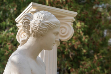 Antique sculptural composition with a woman and a column