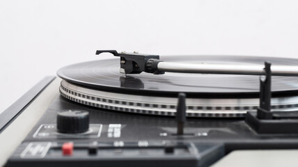 A spinning vinyl record on a turntable. Selective focus, photo in motion.