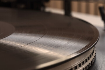 Close-up of a black vinyl record on turntable. Selective focus.