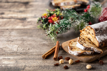 Traditional German Christmas stollen on wooden table. Copy space