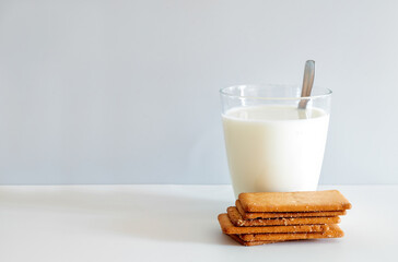 Glass of milk and five rectangular butter biscuits