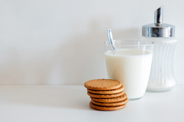 Glass of milk,six round cookies and a sugar bowl