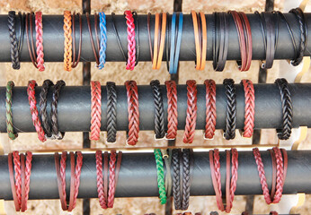 Multi-colored woven leather bracelets to be worn on the wrist
