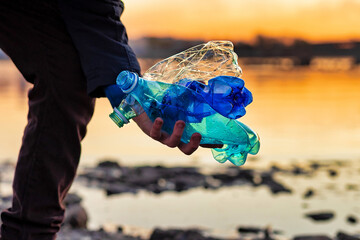 sustainable development concept. a volunteer collecting plastic on the shore.