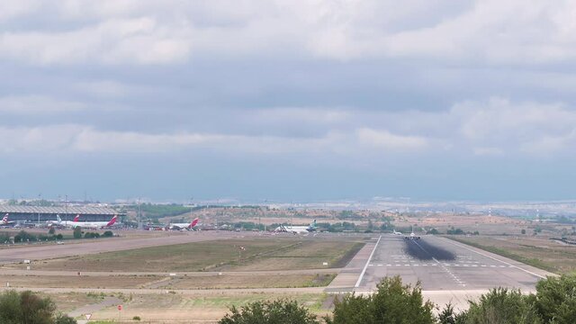 4K video with a panning showing a terminal of the Adolfo Suarez Madrid Barajas airport ending with the follow-up to an A321 bus of the Iberia airline taking off