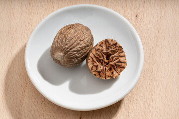 Detailed and large close up shot of nutmeg on a small plate