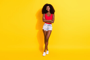 Fototapeta na wymiar Full size photo of optimistic nice brunette lady stand crossed arms wear top shorts isolated on yellow color background