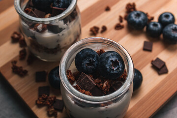 Healthy breakfast: yogurt with berries and muesli in jars. Selective focus.