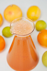 Juicing vegetables and fruits! Bright and colorful fruit drink, oranges, grapes, apples, lemons and limes on a background.