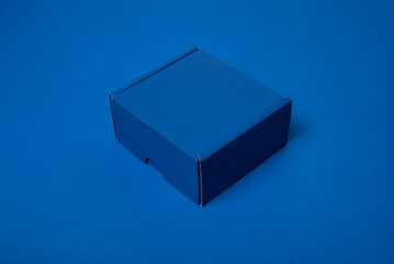 Simple blue cardboard box on color background, top view - obrazy, fototapety, plakaty