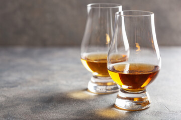 glass of whisky spirit brandy on gray concrete background