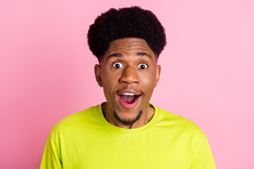 Photo of amazed shocked happy dark skin man reaction news face isolated on pastel pink color background