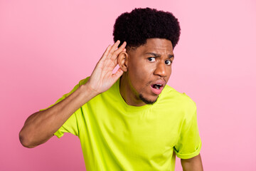 Fototapeta na wymiar Photo of unhappy young dark skin man hold finger head ear listen rumor isolated on pink color background