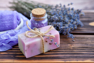 Obraz na płótnie Canvas Lavender spa products on wooden table. Body care products with lavender: soap, salt and dried lavender flowers. Selective focus.