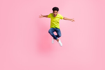 Fototapeta na wymiar Full body photo of young cheerful african guy happy positive smile jump isolated over pink color background