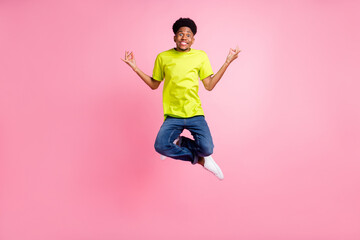 Fototapeta na wymiar Full length body size view of attractive cheerful guy jumping meditating isolated over pink pastel color background