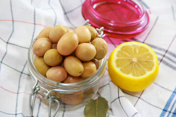 pickled green olives in a glass jar