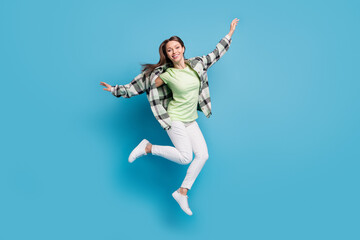 Fototapeta na wymiar Full length profile side photo of young excited girl happy positive smile jump up air isolated over blue color background