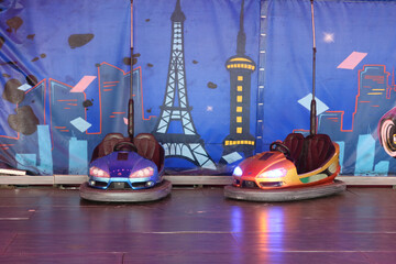 Electric bumper cars ready to use. Funfair entertainment Amusement park with dodgems bumper cars.