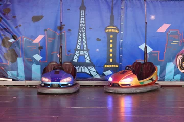 Deurstickers Electric bumper cars ready to use. Funfair entertainment Amusement park with dodgems bumper cars. © PaulSat