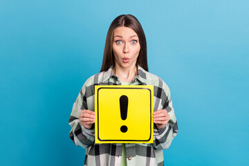 Photo of young girl amazed shocked surprised hold paper card attention sign new driver isolated over blue color background