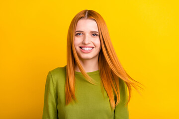 Photo of lovely orange hair young lady blow wind wear green sweater isolated on yellow color...