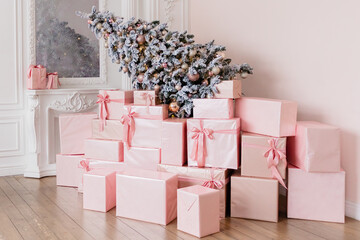 Christmas snow-covered spruce lies in gift boxes. Creative composition and background