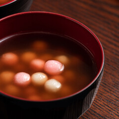 Red and white tangyuan with syrup soup.