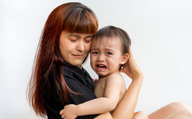 Baby crying while mom hugging. Woman embraces little frustrated son rear view snuggle to mother seeking for support protection of empathy and consoling concept, Family relationships concept