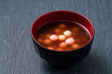 Red and white tangyuan with syrup soup.