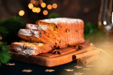  Traditional Christmas cake with fruits. Stollen on a festive Christmas table. Selective focus photo