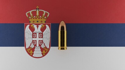 Top down view of a 9mm bullet in the center and on top of the flag of Serbia