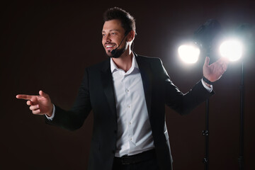 Motivational speaker with headset performing on stage