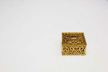 Golden gift box on white background with copy space space.