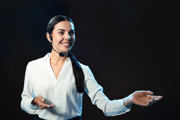 Motivational speaker with headset performing on stage. Space for text