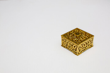Golden gift box on white background with copy space space.