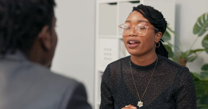 Smiling corporate executive conducts job interview with male candidate for office worker, accepts him into company, hires boy shakes hand congratulates welcomes says goodbye makes contract