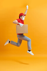 Male employee in cap t-shirt print working as courier dealer hold empty cardboard box