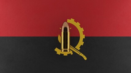 Top down view of a 9mm bullet in the center and on top of the flag of Angola