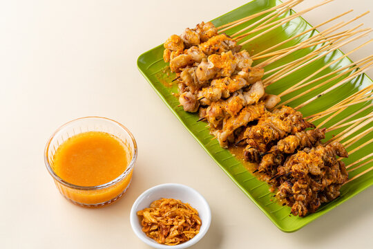Sate taichan or Taichan satay with grilled chicken skin  is a variation of chicken satay grilled and served without peanut or ketchup served with chili sauce. Selective focus , blurry. 