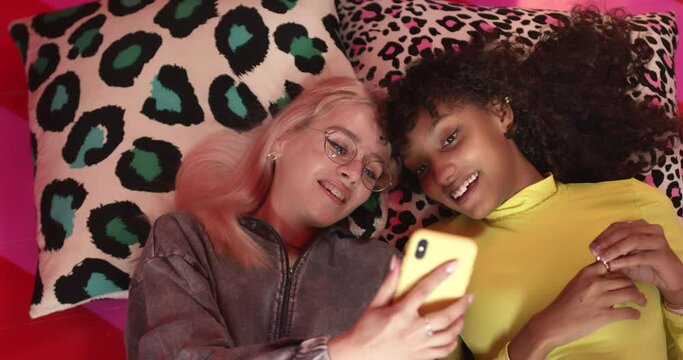 Female friends looking at a smartphone together