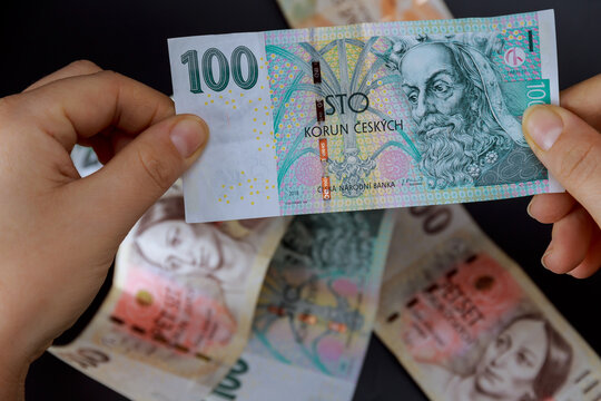 Crown holding a girl in his hands on a black background. Czech money. European currency.